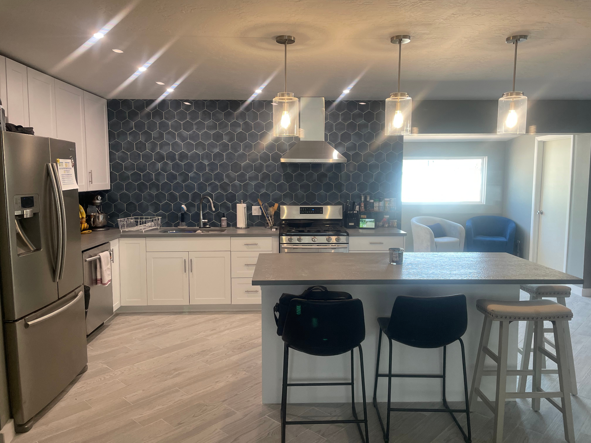 Modern kitchen remodel with hexagon tile backsplash and pendant lighting